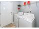 Functional laundry room with side-by-side washer and dryer units, plus wire shelving at 100 Pine Hall Dr, Goose Creek, SC 29445