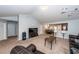 Bright living room with neutral carpet, large TV, open floor plan to dining and kitchen area at 100 Pine Hall Dr, Goose Creek, SC 29445
