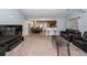 Open living room with neutral carpet, leather sofa, bar stools, and view into kitchen and dining area at 100 Pine Hall Dr, Goose Creek, SC 29445