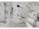 Elegant bathroom with marble tile walls, a modern shower, and a separate soaking tub with black fixtures at 1019 Royalist Rd, Mount Pleasant, SC 29464