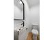 Modern powder room features a wall mounted basin sink with marble countertop, matte black hardware and updated fixtures at 1019 Royalist Rd, Mount Pleasant, SC 29464