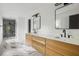 Modern bathroom featuring double sink vanity, large mirrors, a glass enclosed shower and marble floor tiles at 1019 Royalist Rd, Mount Pleasant, SC 29464