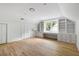 Bright bedroom with a built-in desk, shelving and drawers, and hardwood floors at 1019 Royalist Rd, Mount Pleasant, SC 29464