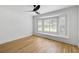 Bright bedroom featuring a bay window with wooden shutters and hardwood flooring at 1019 Royalist Rd, Mount Pleasant, SC 29464