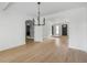 Bright dining room with hardwood floors and modern light fixture, connecting to the kitchen and living spaces at 1019 Royalist Rd, Mount Pleasant, SC 29464