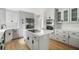 Bright kitchen features white cabinets, stainless steel appliances, and a large center island with cooktop at 1019 Royalist Rd, Mount Pleasant, SC 29464