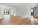 Expansive living area with hardwood floors, showcasing seamless transitions to the kitchen and outdoor spaces at 1019 Royalist Rd, Mount Pleasant, SC 29464
