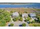 Aerial scene showing waterfront homes with private docks along a tranquil waterway, with lush green foliage and neighborhood streets at 104 Wando Reach Rd, Wando, SC 29492