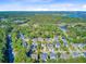 An aerial view of a charming neighborhood near a forest and bay, showcasing the well-maintained properties at 104 Wando Reach Rd, Wando, SC 29492