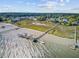 Aerial photograph displays picturesque waterfront community docks and the nearby residences along the shoreline and tranquil marshland at 104 Wando Reach Rd, Wando, SC 29492