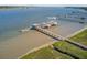An aerial view capturing a dock with boats, adjacent to wetlands and waterways, offering waterfront recreational opportunities at 104 Wando Reach Rd, Wando, SC 29492
