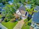 Lovely two-story home featuring a covered front porch, palm trees, and an attached two-car garage at 104 Wando Reach Rd, Wando, SC 29492