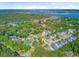 An aerial shot of a quiet residential area surrounded by lush trees with a distant view of a bridge and waterway at 104 Wando Reach Rd, Wando, SC 29492