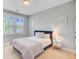 Well-lit bedroom features neutral walls, carpet, and windows with white shutters at 104 Wando Reach Rd, Wando, SC 29492