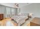 Bright bedroom with wood floors, windows with shutters, and ceiling fan at 104 Wando Reach Rd, Wando, SC 29492