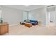 Upstairs bonus room with a blue sofa, TV, and natural light from the window at 104 Wando Reach Rd, Wando, SC 29492