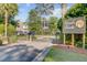 A gated entrance to Wando Pointe, a private waterfront community, is showcased with lush greenery and mature trees at 104 Wando Reach Rd, Wando, SC 29492
