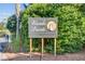 The Wando Pointe private waterfront community sign is displayed near lush greenery and palm trees at 104 Wando Reach Rd, Wando, SC 29492