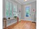 Entryway with hardwood floors, console table, and large window with shutters at 104 Wando Reach Rd, Wando, SC 29492