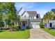 Charming two-story home features a landscaped yard, covered porch, and two-car garage at 104 Wando Reach Rd, Wando, SC 29492