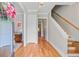Bright foyer with hardwood floors, staircase, and views into adjoining rooms at 104 Wando Reach Rd, Wando, SC 29492