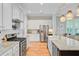 Updated kitchen boasts white cabinets, stainless steel appliances, and granite countertops at 104 Wando Reach Rd, Wando, SC 29492