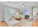 Bright living room with a fireplace, built-ins, and large windows for natural light at 104 Wando Reach Rd, Wando, SC 29492