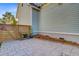 Fenced side yard with paver patio, raised garden bed, and convenient access creates a functional outdoor area at 104 Wando Reach Rd, Wando, SC 29492