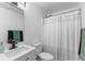 Clean bathroom showcases a white vanity with modern fixtures, a toilet, and a shower with a striped curtain at 109 Sawmill Dr, Summerville, SC 29483