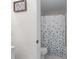 Clean bathroom showcases a toilet, shower and a stylish blue and white patterned shower curtain at 109 Sawmill Dr, Summerville, SC 29483