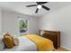 Bright bedroom with a full bed, wooden dresser and view out the window to a tree lined street at 109 Sawmill Dr, Summerville, SC 29483