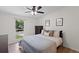 Comfortable bedroom features a ceiling fan, a plush bed with decorative pillows, and a bright window view at 109 Sawmill Dr, Summerville, SC 29483