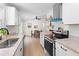 This kitchen features an open concept, stainless steel appliances, white cabinetry, and granite countertops at 109 Sawmill Dr, Summerville, SC 29483