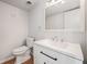 Bathroom featuring a white vanity, a modern faucet, a large mirror, and a toilet at 111 Elmwood Ave # A, Ladson, SC 29456