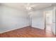 Bright bedroom featuring wood-look flooring, neutral walls, and a classic ceiling fan at 111 Elmwood Ave # A, Ladson, SC 29456