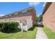 Back exterior of a brick villa featuring a private patio area with white privacy fence at 111 Elmwood Ave # A, Ladson, SC 29456