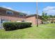 Exterior view of brick villas with well-manicured lawn, white fencing, and lush greenery at 111 Elmwood Ave # A, Ladson, SC 29456