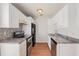Well-lit kitchen boasting white cabinets and stainless steel appliances at 111 Elmwood Ave # A, Ladson, SC 29456