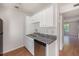 Close up of the kitchen with white cabinets, granite counters and stainless dishwasher and sink at 111 Elmwood Ave # A, Ladson, SC 29456