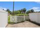 Private patio area with white fence providing privacy and a view of palm trees at 111 Elmwood Ave # A, Ladson, SC 29456