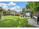 Large backyard featuring a deck, a fire pit area with chairs, and a detached garage with a covered area at 1125 Oceanview Rd, Charleston, SC 29412