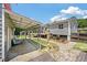 Backyard showcasing an outbuilding, patio, garden area, and walkway leading to the main house at 1125 Oceanview Rd, Charleston, SC 29412