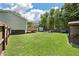 Spacious backyard features a deck, a fire pit area with seating, a storage shed, and ample greenery at 1125 Oceanview Rd, Charleston, SC 29412