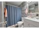 Cozy bathroom featuring a shower with blue curtain, stylish vanity with mirror and mosaic tile accents at 1125 Oceanview Rd, Charleston, SC 29412