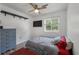 Bedroom features laminate flooring, natural light, and a ceiling fan at 1125 Oceanview Rd, Charleston, SC 29412