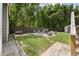 Cozy fire pit area with chairs offers a perfect outdoor gathering space, surrounded by lush greenery and a privacy fence at 1125 Oceanview Rd, Charleston, SC 29412