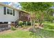 Close-up of home's entry shows beautiful landscaping and a welcoming front porch with an American flag at 1125 Oceanview Rd, Charleston, SC 29412