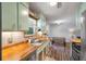 Charming kitchen features wood counters, stainless sink, and vintage-inspired cabinets and stainless steel appliances at 1125 Oceanview Rd, Charleston, SC 29412