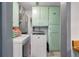Functional laundry room with mint green cabinets, washer, dryer, and tile flooring at 1125 Oceanview Rd, Charleston, SC 29412