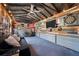 Outbuilding interior featuring a cozy lounge area, mounted TV, dartboard, and eclectic decor at 1125 Oceanview Rd, Charleston, SC 29412